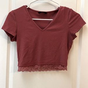 Dusty pink crop top with a bottom trim of lace